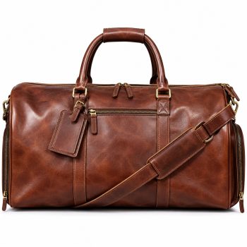 Front view of Mizon International genuine leather brown weekender duffel bag showing double rounded handles, top double zipper, exterior front zip pocket, padded shoulder strap and antique gold-tone metal fittings.