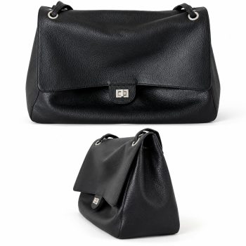 Back view of a women's black genuine leather shoulder bag showing the pebbled leather texture, softly structured rectangular silhouette and silver-tone strap eyelets.