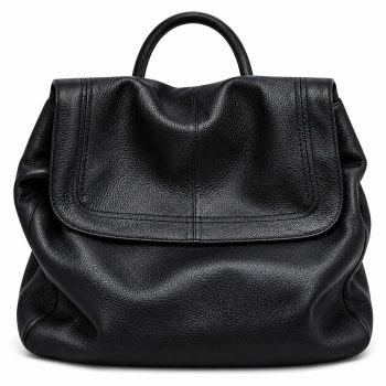 Front view of Mizon International women's genuine leather slouchy flap backpack in black, featuring a pebbled texture, large rounded fold-over flap, softly gathered sides and top carry handle.