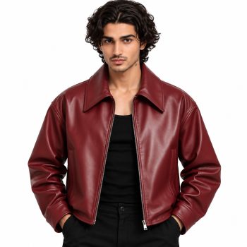 Male model wearing Mizon International men's burgundy red genuine leather jacket with a classic fold-down shirt collar, central front zipper, smooth wine-red exterior, long sleeves and gathered-looking cuffs against a white background.