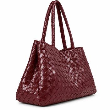 Angled view of Mizon International women's burgundy genuine leather woven tote bag showing an intricate basket-weave pattern, braided shoulder handles, softly structured side panels and deep wine-red finish.