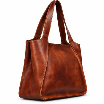Front view of Mizon International women's cognac-brown genuine leather structured tote bag featuring two wide integrated shoulder handles, distinctive angled front panels, contrast stitching and a softly structured trapezoidal silhouette.