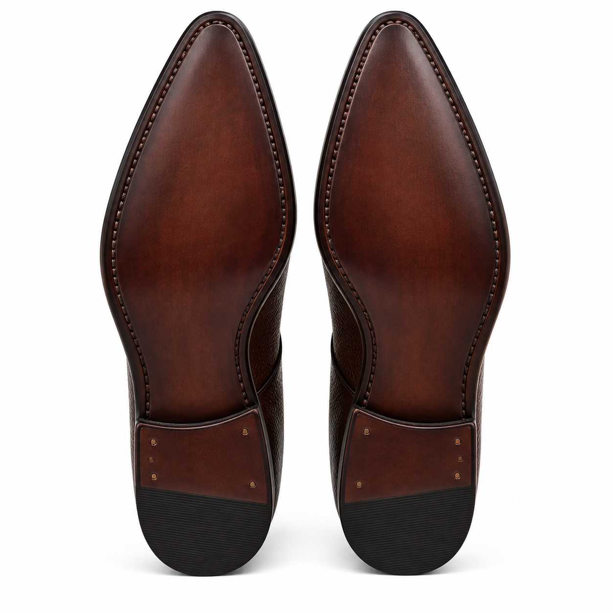 Front view of a pair of dark chocolate-brown genuine leather chukka-style ankle boots featuring pebbled grain-textured uppers, dark brown laces, polished pointed almond-shaped toes, tan-colored interiors, and black sole edges against a white background.