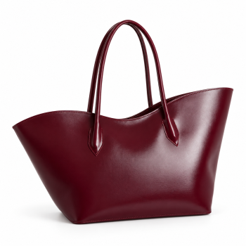 Angled view of Mizon International women's burgundy genuine leather tote bag featuring a smooth wine-red exterior, curved upper edge, two long slim shoulder handles, pointed stitched attachments and wide tapered silhouette.